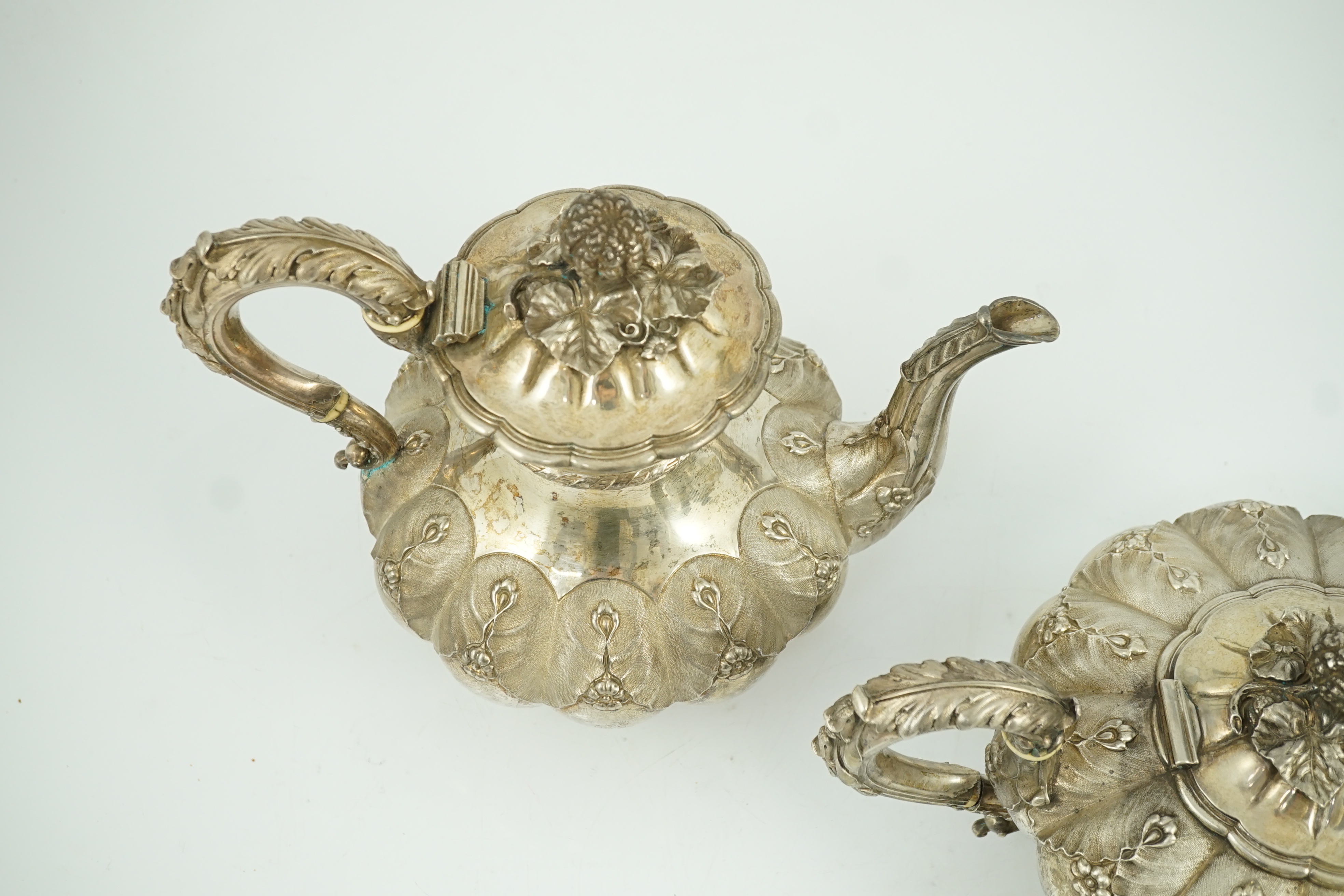 A George IV silver melon shaped coffee pot and matching tea pot by The Barnards